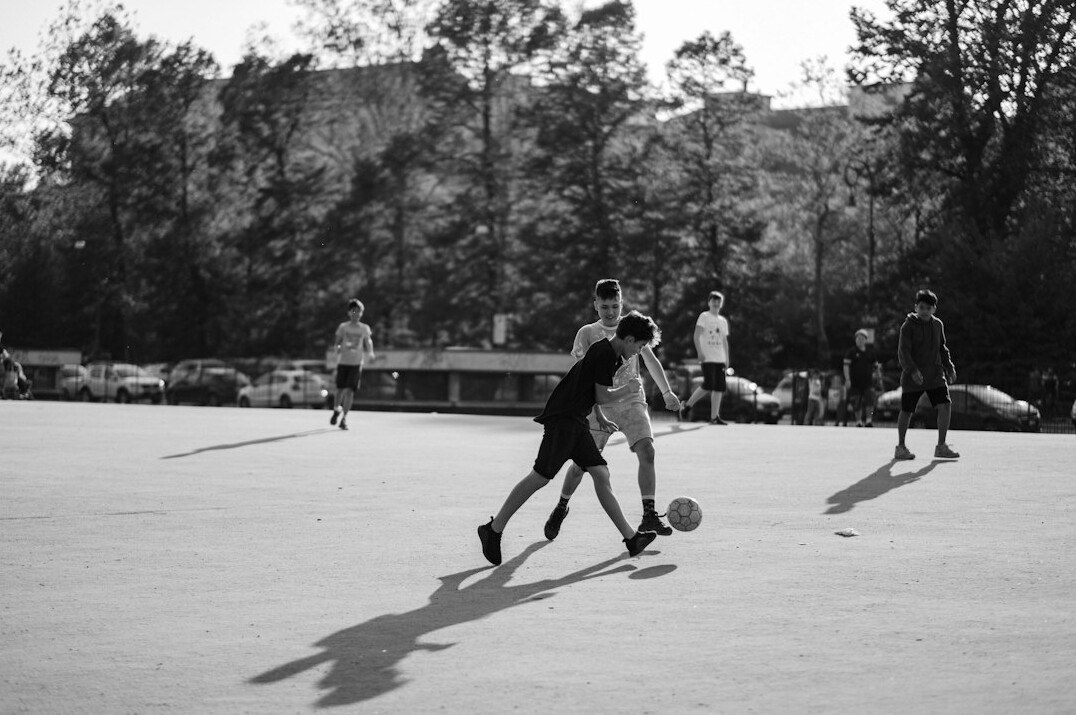 kids playing soccer in park