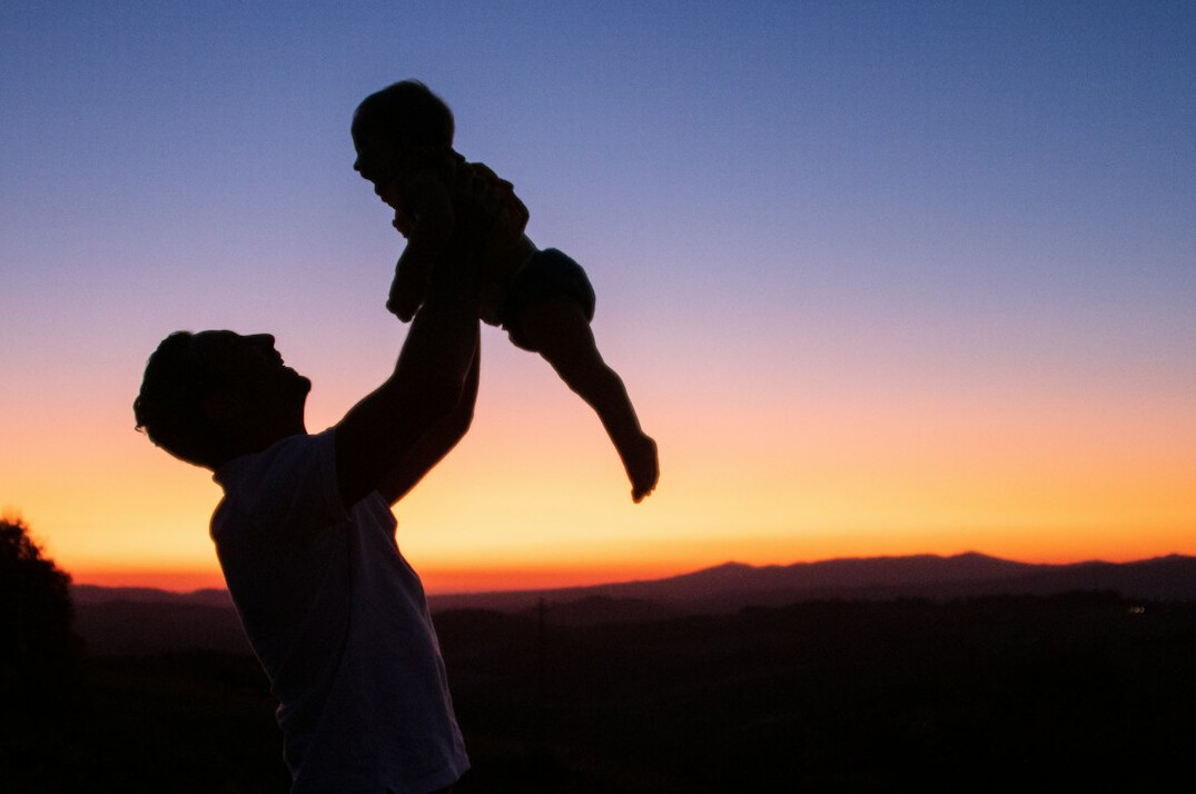 father carrying child