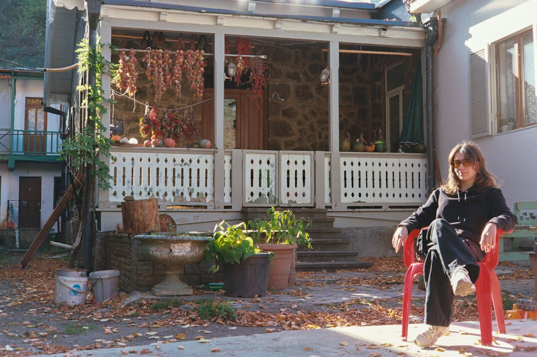 Elderly woman knitting on her porch